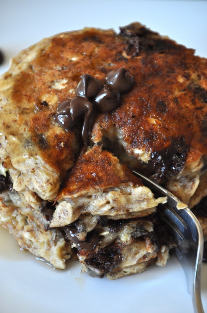 Slicing into Chocolate Chip Oatmeal Cookie Pancakes for a delicious vegan breakfast