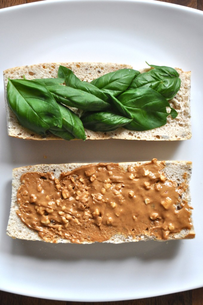 peanut butter basil sandwich3 Plate with two slices of bread topped with basil on one and peanut butter on the other