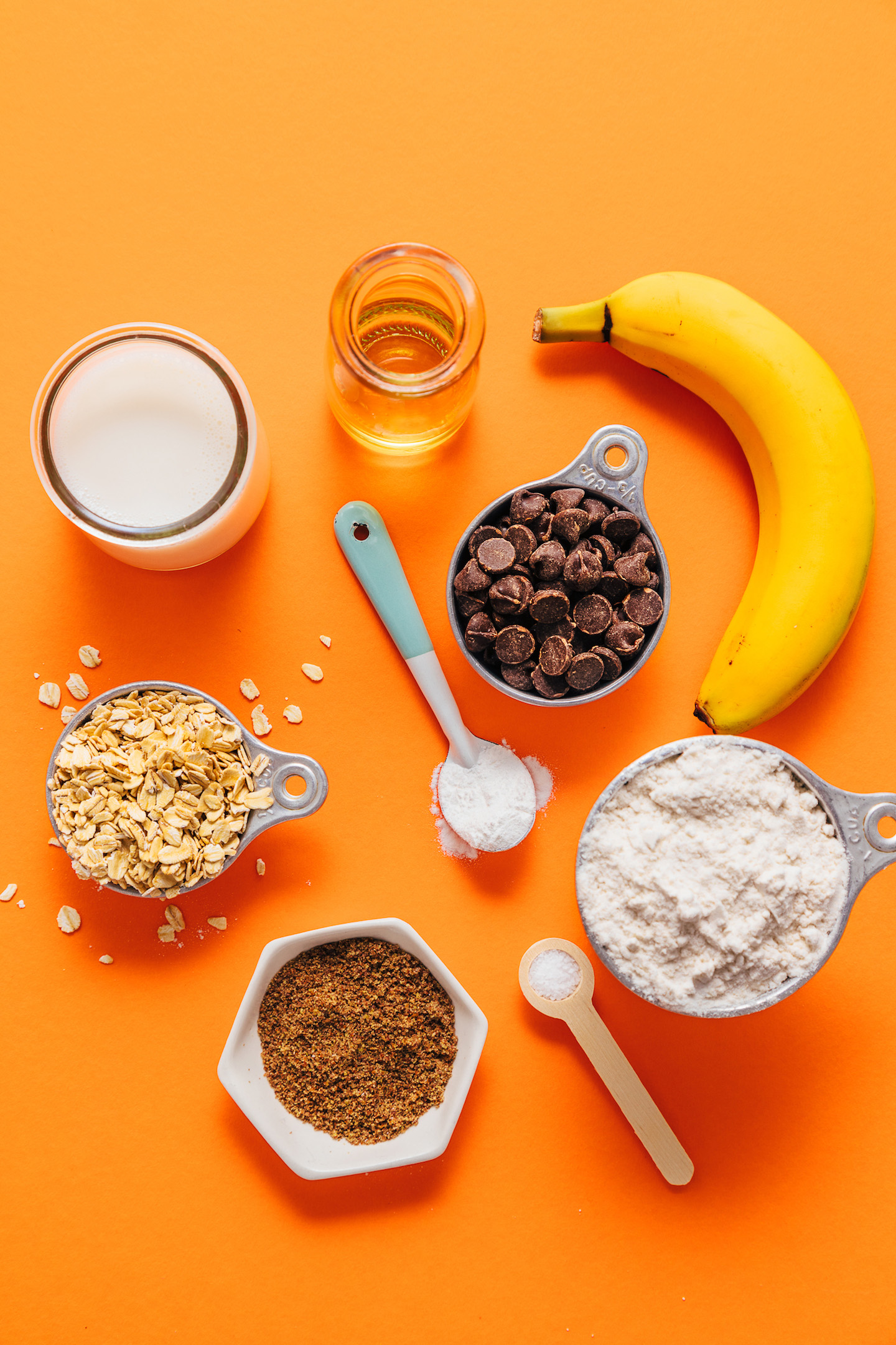 Orange background with ingredients for making our Chocolate Chip Banana Bread Waffles recipe
