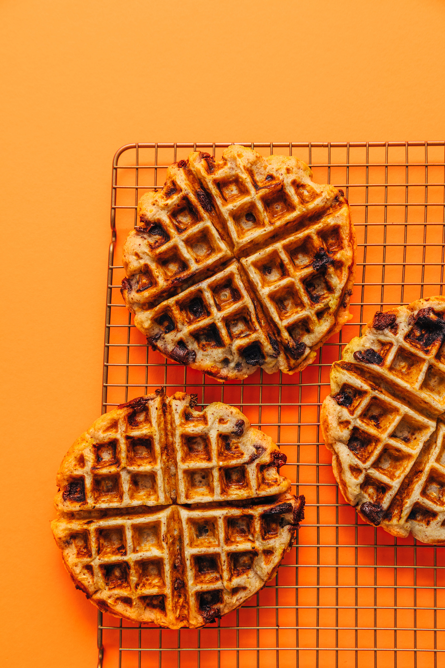 Cooling rack with three freshly cooked Chocolate Chip Banana Bread Waffles