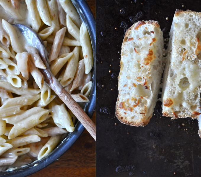 Pan of our Healthy Alfredo Sauce alongside a baking sheet with slices of garlic bread