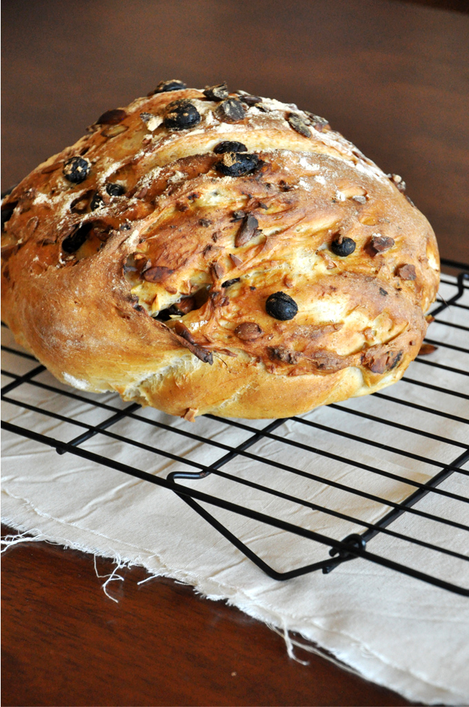 Muesli Bread! by Minimalist Baker Cooling rack with a freshly baked loaf of Muesli Bread on it