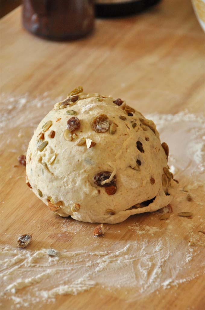 Rising Muesli Bread - Minimalist Baker! Loaf of unbaked Muesli Bread with nuts and dried fruit rolled into it