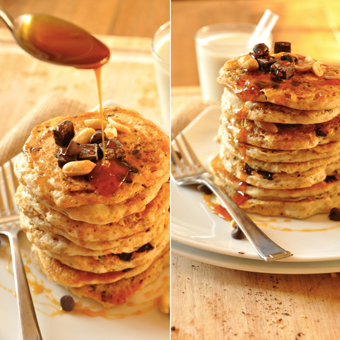 Drizzling caramel sauce onto a stack of Vegan Snickers Pancakes
