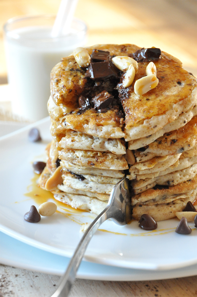 Using a fork to cut out a slice of Vegan Snickers Pancakes for a special breakfast