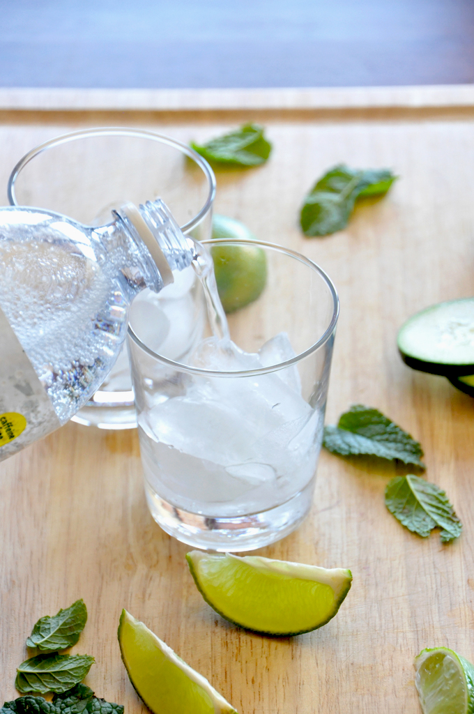 cucumber coolers by minimalist baker Pouring tonic water into glasses to make our Cucumber Cooler Cocktails recipe