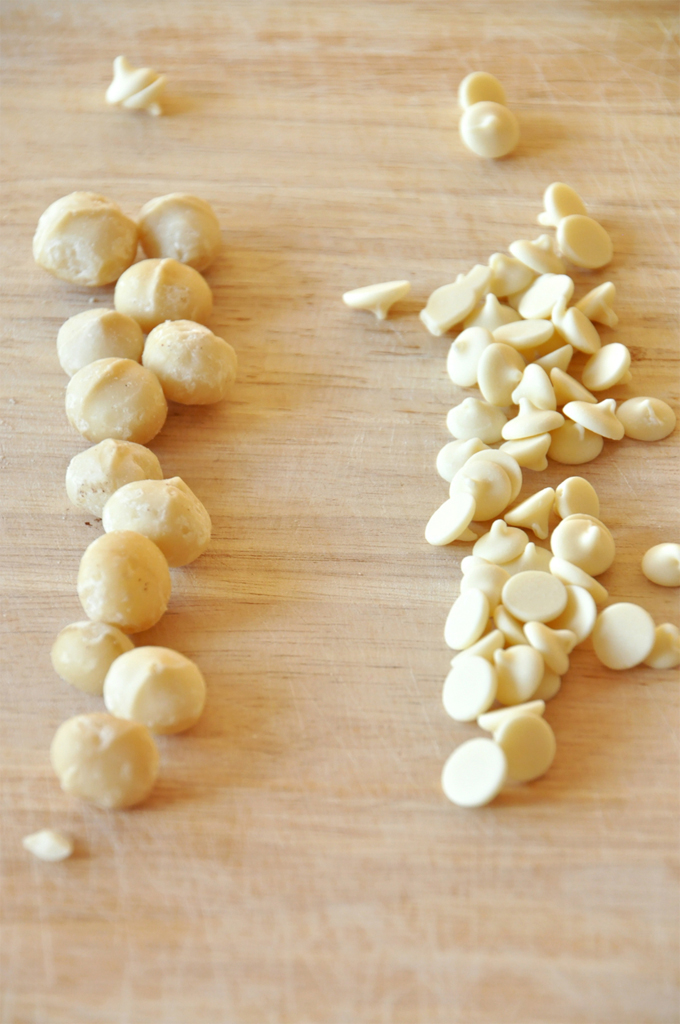 white chocolate chip macadamia nut pancakes! Cutting board with macadamia nuts and white chocolate chips for making delicious pancakes