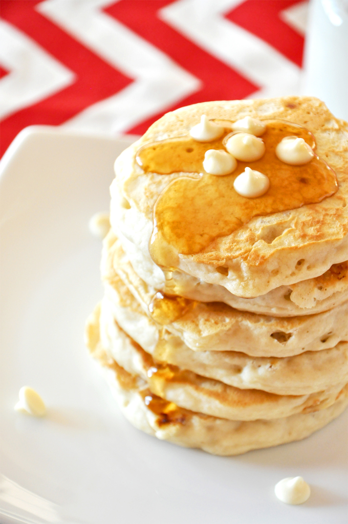 white chocolate macadamia nut pancakes!!! Tall stack of White Chocolate Macadamia Nut Pancakes topped with syrup and chocolate chips