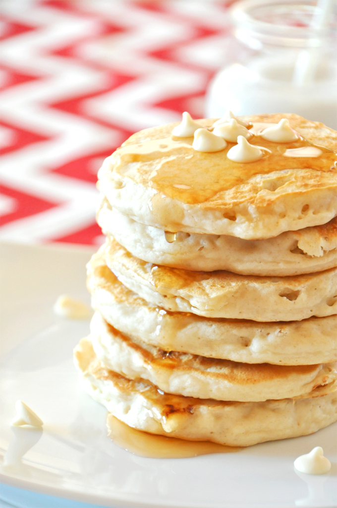 white chocolate macadamia pancakes! Minimalist Baker Close up shot of a fluffy stack of vegan White Chocolate Macadamia Nut Pancakes