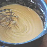 Stirring a pot of Caramel Cinnamon Roll Glaze