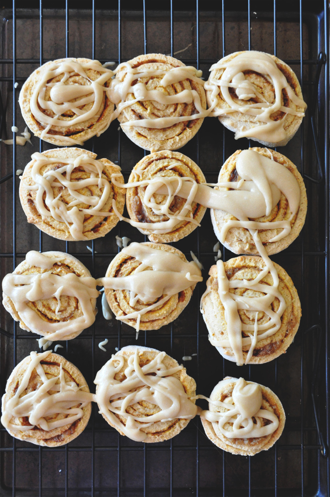 Batch of Pumpkin Cinnamon Roll Cookies drizzled with homemade icing