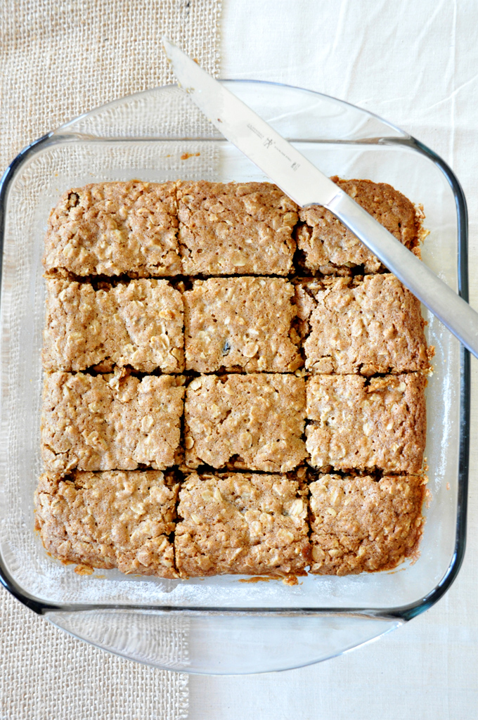Chai Spiced Oatmeal Raisin Cookie Bars! Baking pan with a sliced batch of Chai-Spiced Oatmeal Raisin Bars