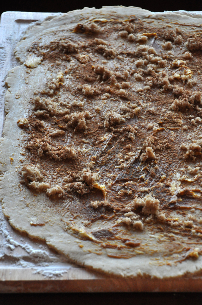 Cutting board with rolled out dough and filling for our Pumpkin Cinnamon Roll Cookies recipe