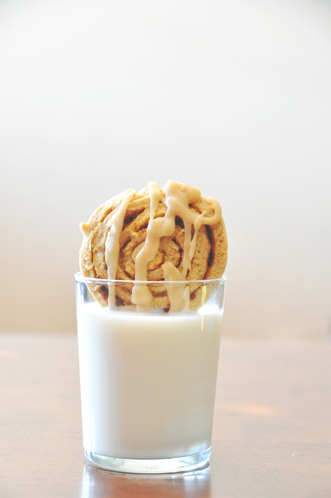 One of our delicious Pumpkin Cinnamon Roll Cookies dipped into milk
