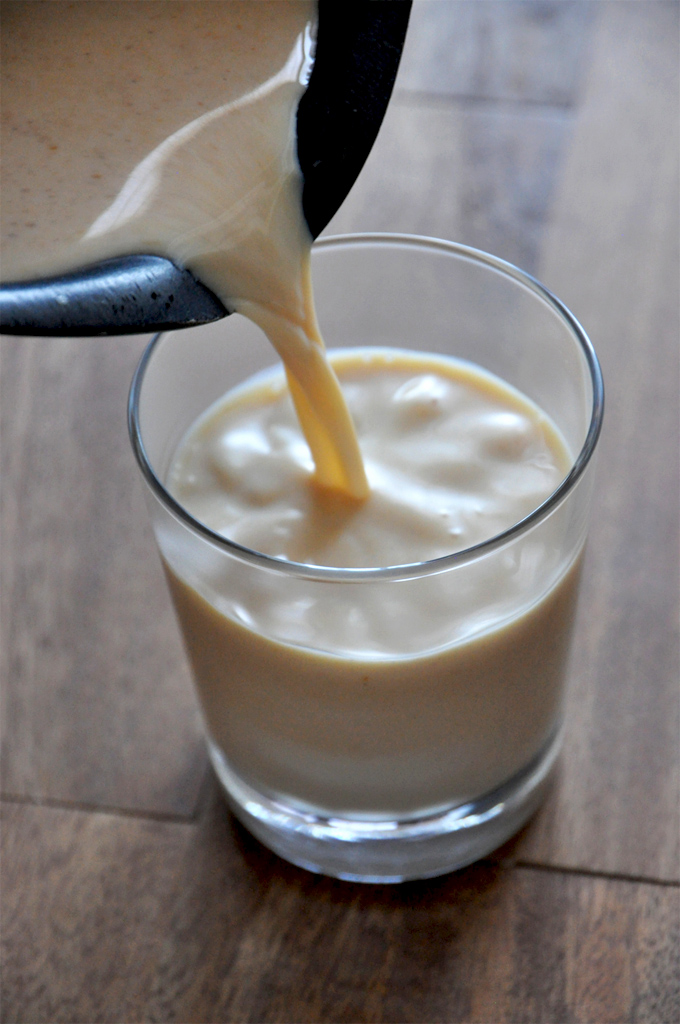 Pumpkin White Hot Chocolate with Booze! Pouring a glass of our delicious Boozy Pumpkin White Hot Chocolate