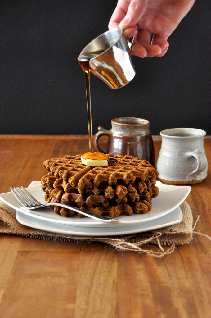 Vegan Gingerbread Waffles || The Minimalist Baker Pouring syrup onto a stack of Vegan Gingerbread Waffles