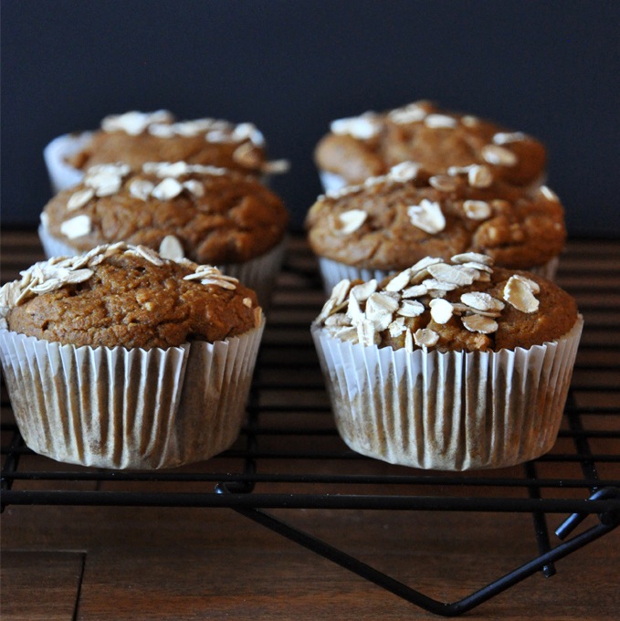Cooling rack filled with homemade Vegan Pumpkin Apple Muffins topped with oats