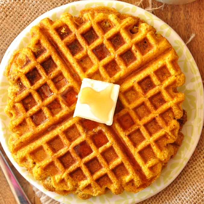 Top down shot of a Vegan Pumpkin Cornbread Waffle topped with vegan butter and syrup