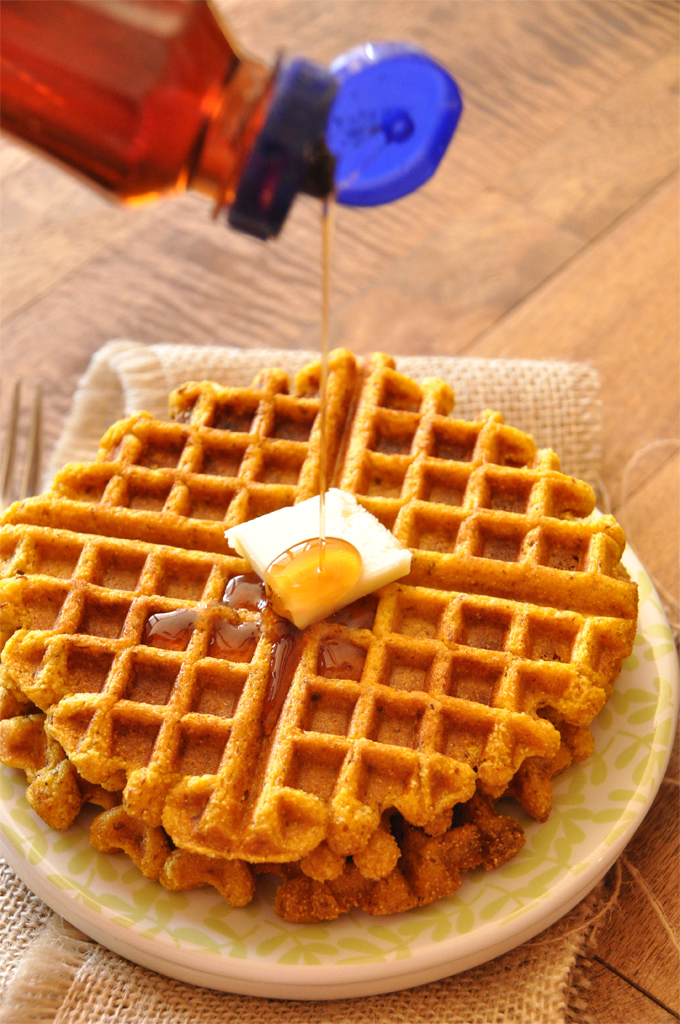Drizzling syrup onto a batch of our Vegan Pumpkin Cornbread Waffles recipe