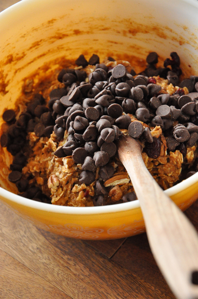 Stirring chocolate chips into a bowl of our Vegan Everything Breakfast Cookie dough