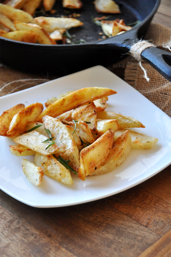 Plate of gluten-free healthier french fries with fresh rosemary
