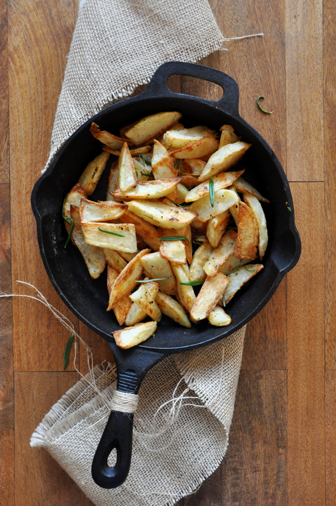 Baked Rosemary Garlic Fries Cast-iron skillet of homemade Crispy Baked Rosemary Garlic Fries