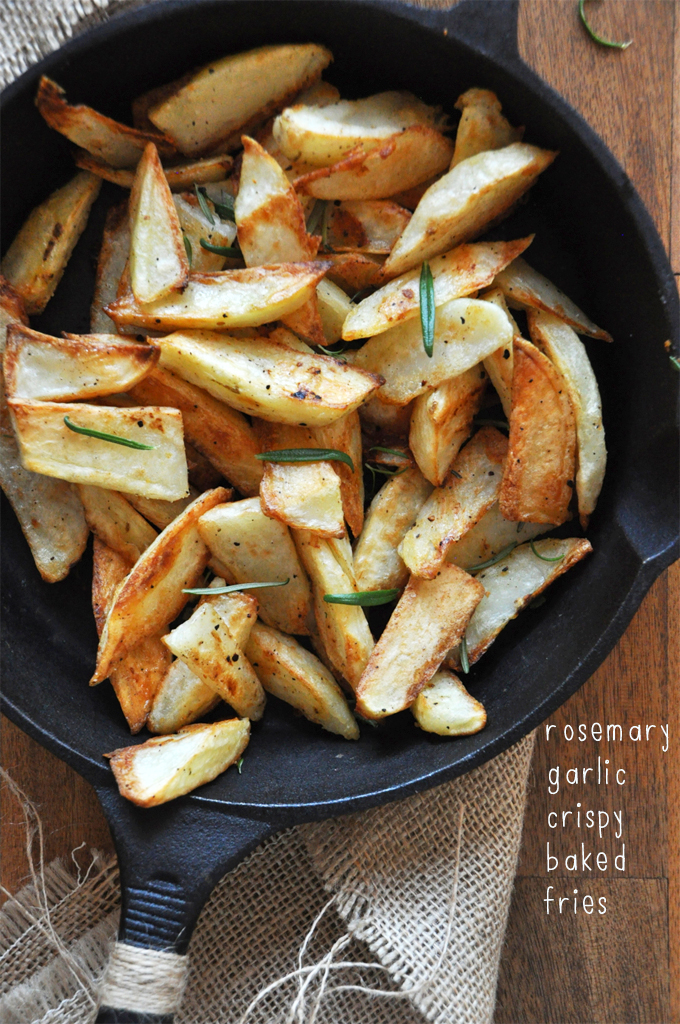 Crispy Baked Rosemary Fries || Minimalist Baker Cast-iron skillet filled with a batch of our homemade Crispy Baked Rosemary Garlic Fries