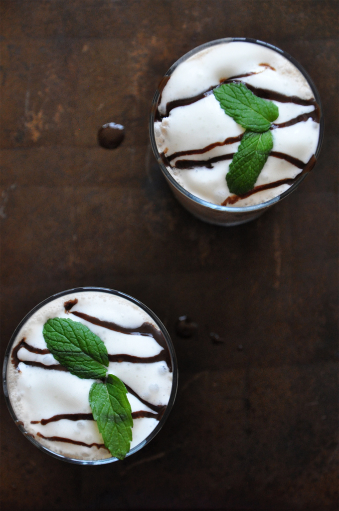Peppermint Mocha Frappe with Coconut Milk | minimalistbaker Baking sheet with glasses of Peppermint Mocha Frappe topped with whipped cream and mint leaves