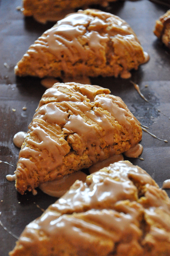 Pumpkin scones with maple glaze Close up shot of delicious homemade Pumpkin Scones drizzled with Maple Glaze