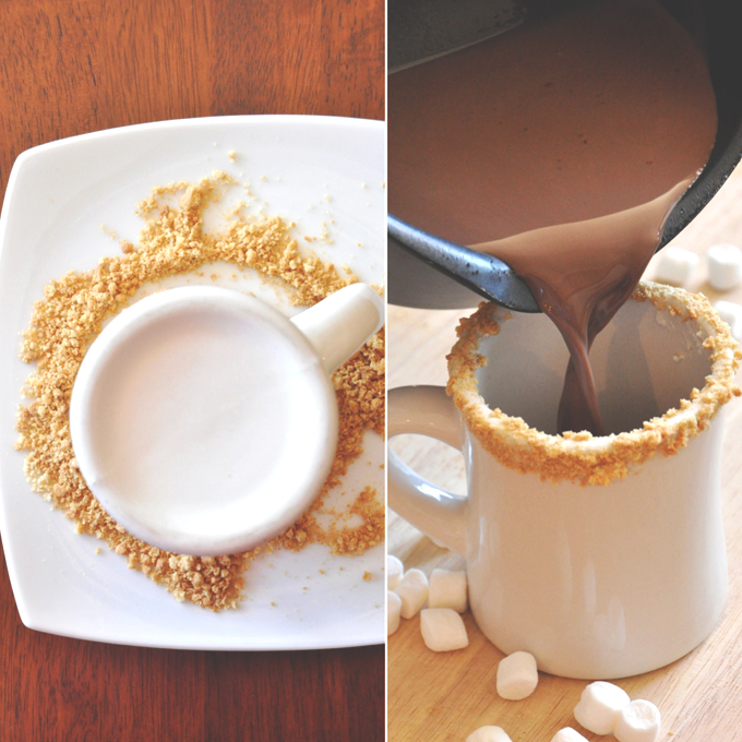 Smores Hot Cocoa | Minimalist Baker Pouring hot chocolate into a mug rim lined with graham cracker crumbs