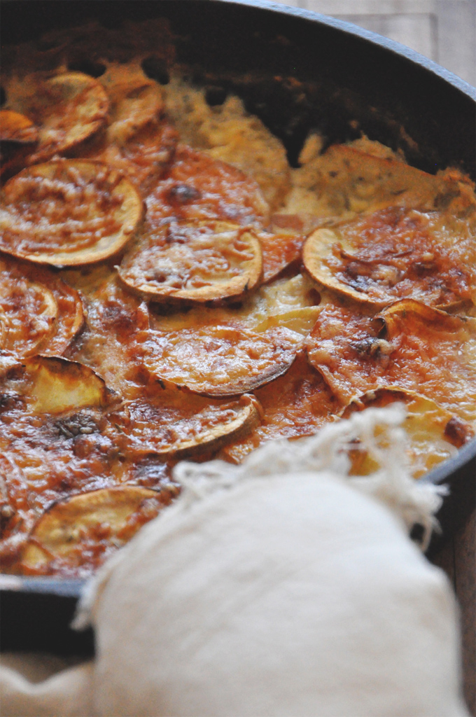 Batch of our Sweet Potato Parmesan Gratin recipe in a cast-iron skillet