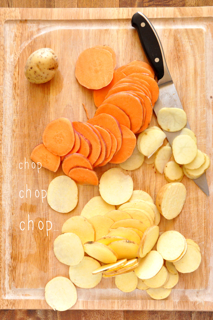 Sliced sweet potatoes and gold potatoes on a cutting board for making Sweet Potato Parmesan Gratin