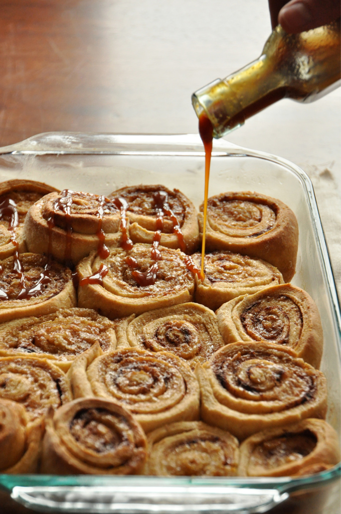 Bourbon Caramel Glaze Pouring caramel sauce over a batch of our Overnight Honey Wheat Cinnamon Rolls recipe