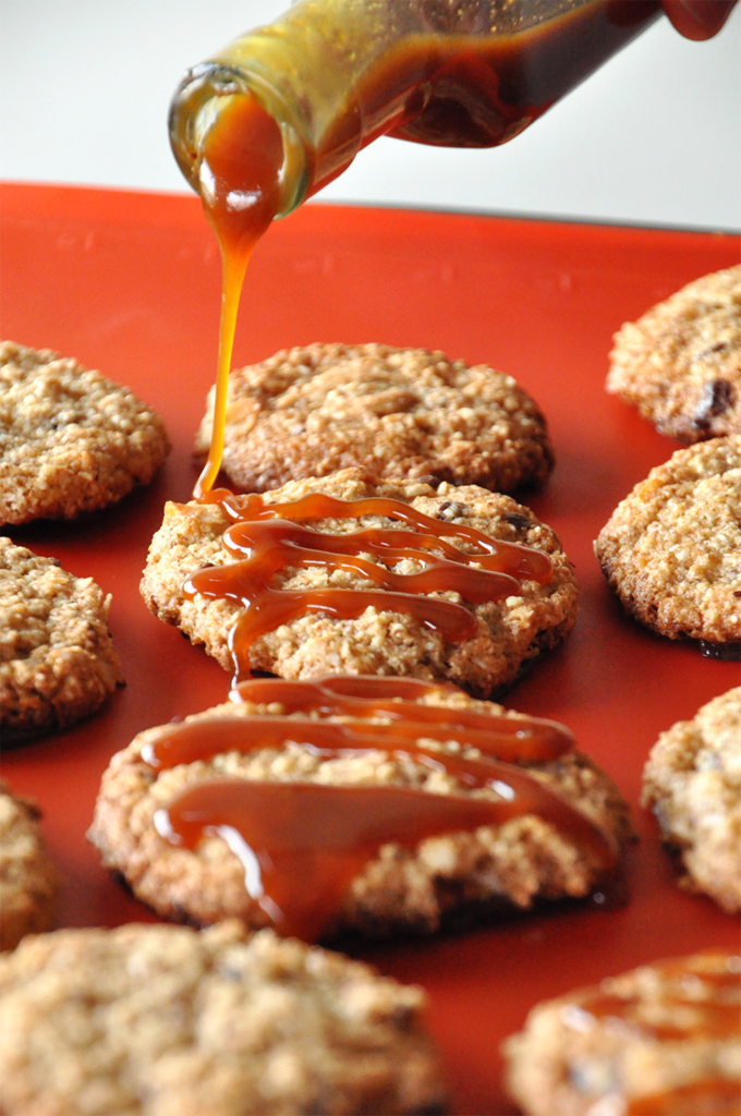 Drizzling caramel sauce onto homemade samoa cookies