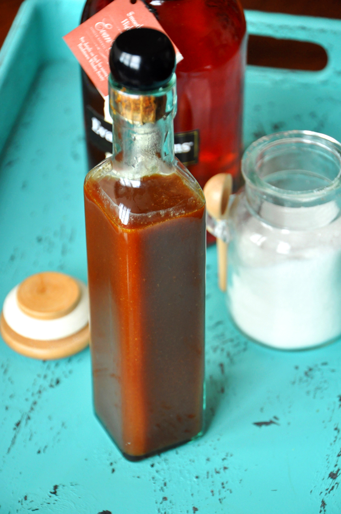 Bright blue tray with bourbon, sugar, and a bottle of homemade Bourbon Caramel Sauce