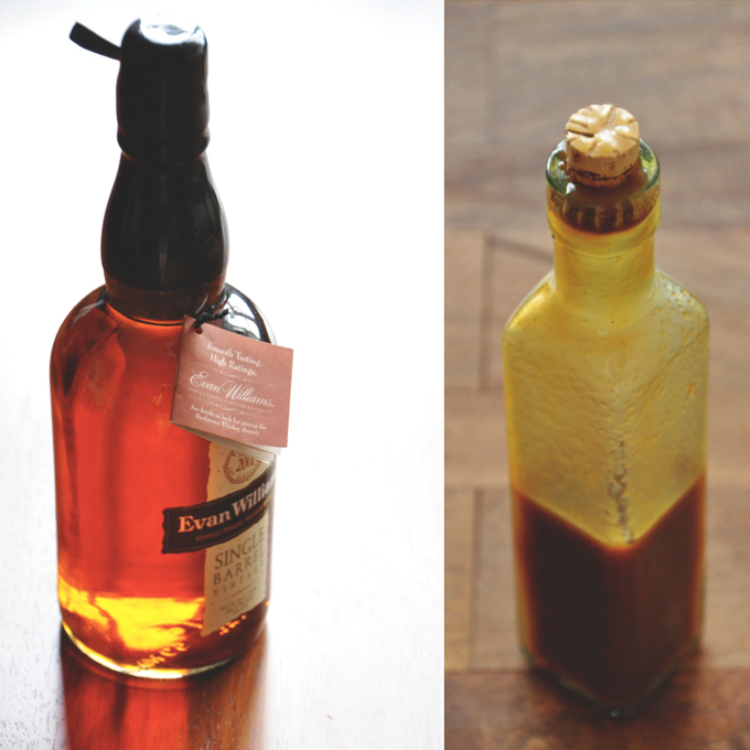 Bottle of bourbon and bottle of caramel sauce made with the bourbon