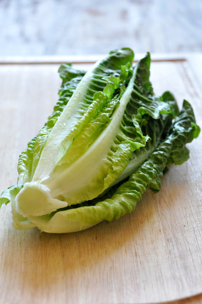 Cutting board with a head of romaine lettuce for making a Broiled Romaine Salad