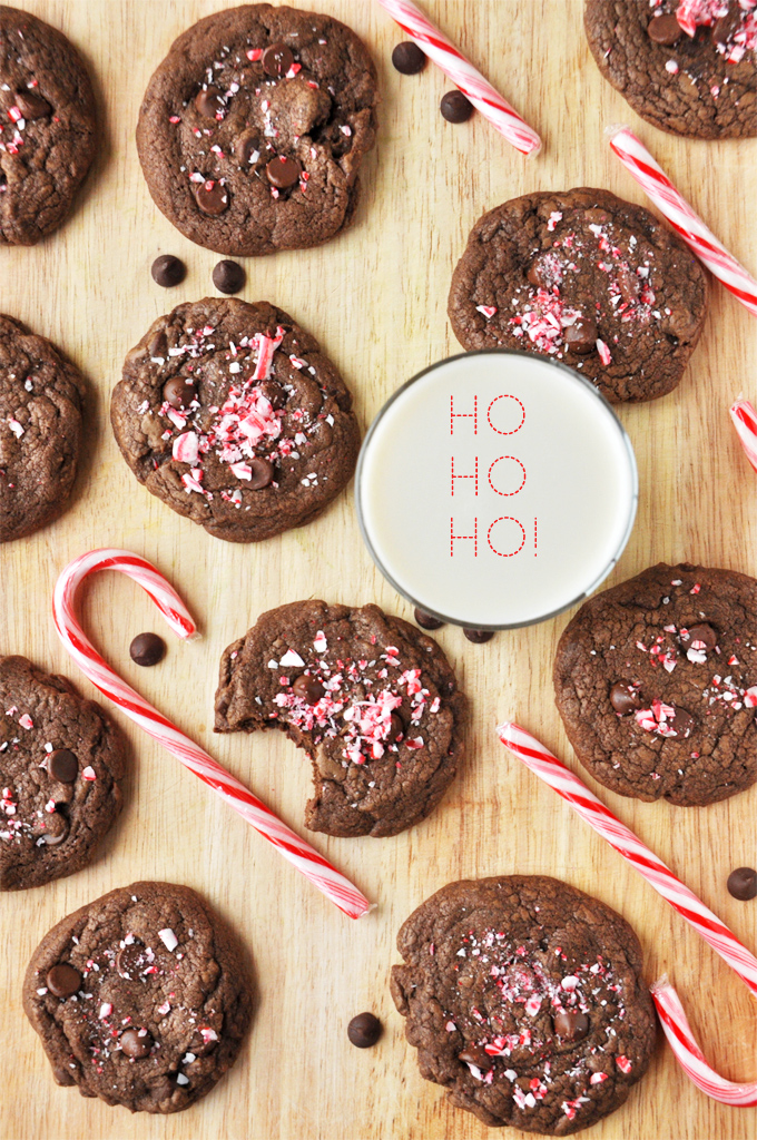 Batch of Chewy Double Chocolate Peppermint Cookies on a cutting board with milk for Santa