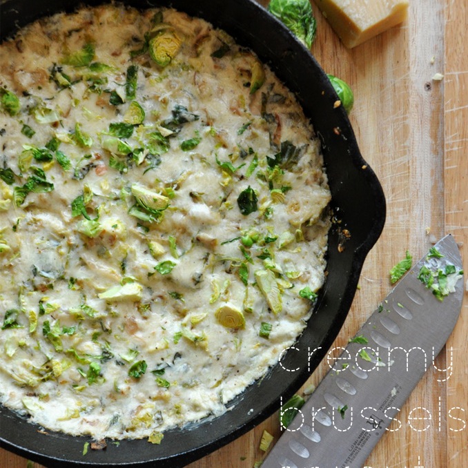 Chef's knife beside a skillet of Creamy Brussels Sprout & Shallot Dip