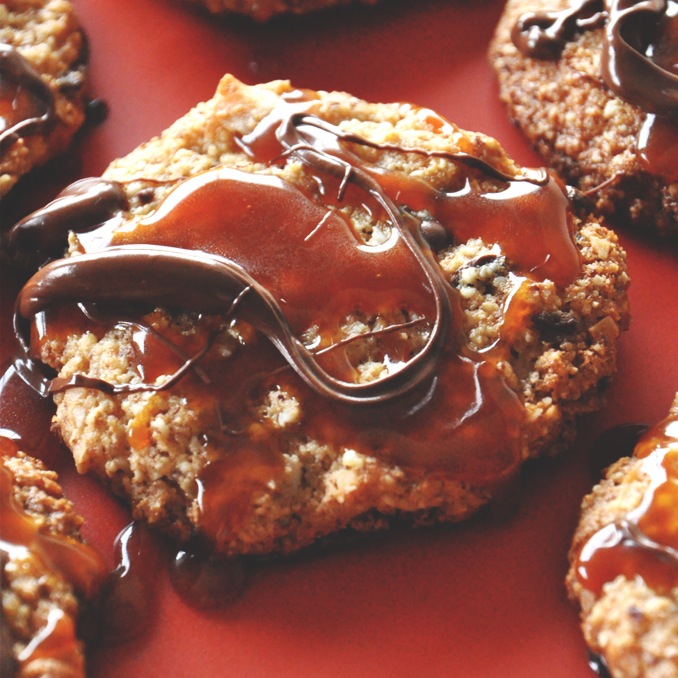 Batch of Gluten-Free Bourbon Caramel Samoa Cookies on a red background