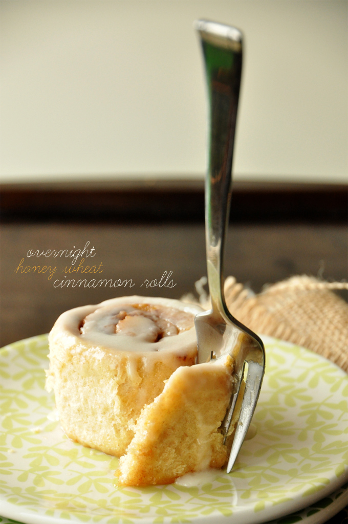 Overnight Honey Wheat Cinnamon Rolls | Minimalist Baker Using a fork to grab a bite of one of our Overnight Honey Wheat Cinnamon Rolls