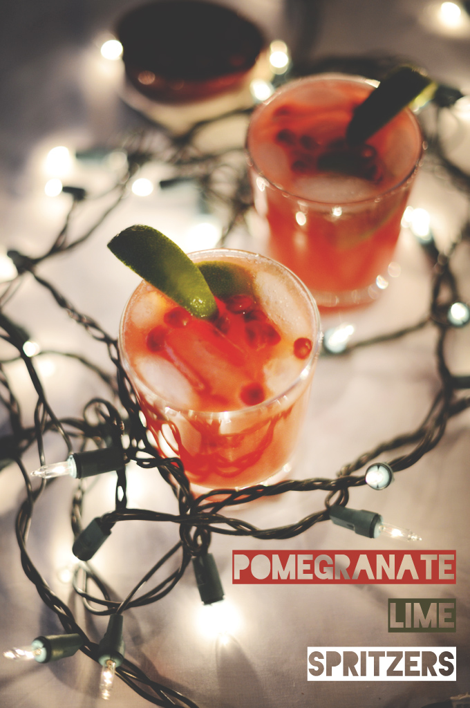 Glasses of Pomegranate Lime Spritzers with lime wedges on the rims