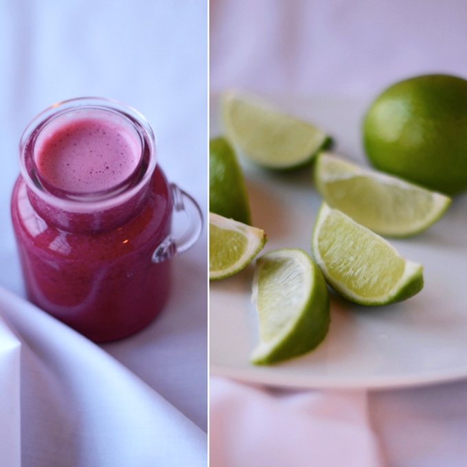 Jar of pomegranate juice and fresh lime wedges for making Pomegranate Lime Spritzers