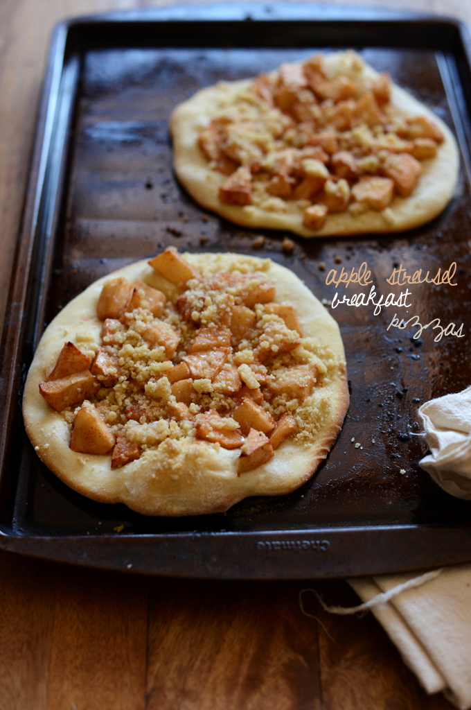Two freshly baked Apple Streusel Breakfast Pizzas on a baking sheet