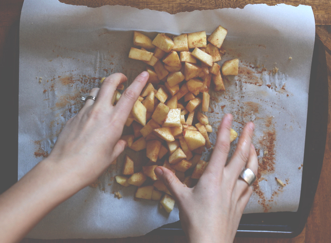 Tossing cubed apple pieces with cinnamon for making our Apple Breakfast Pizzas recipe