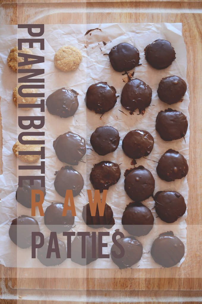 Homemade Raw Peanut Butter Patties setting up on a parchment-lined cutting board