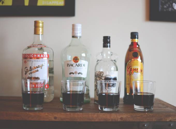 Bottle of liquor mixed in glasses with root beer for creating the best Root Beer Cocktail