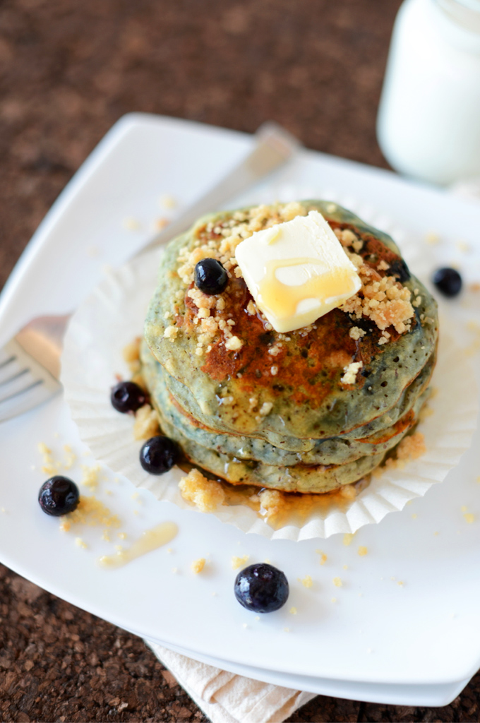 Stack of Blueberry Muffin Pancakes topped with vegan butter and streusel