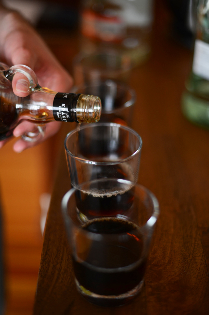 Pouring vodka into a glass to make Vodka Root Beer Floats