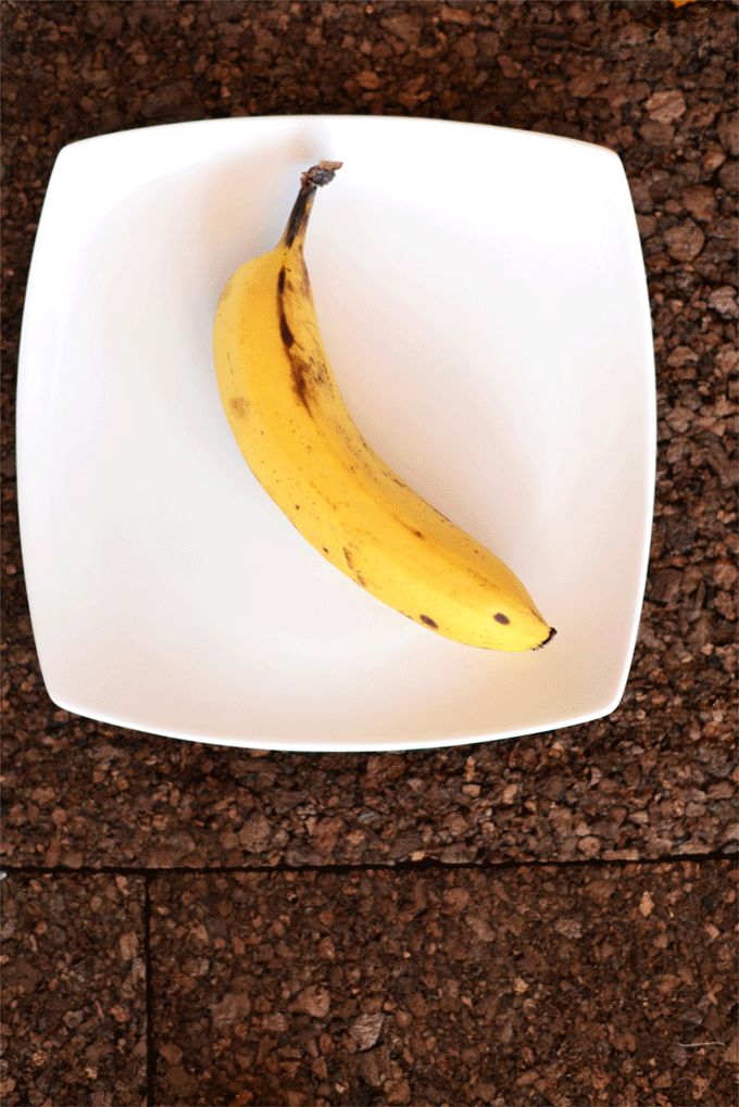 Peeling and mashing a banana for Banana Nut Muffin Pancakes
